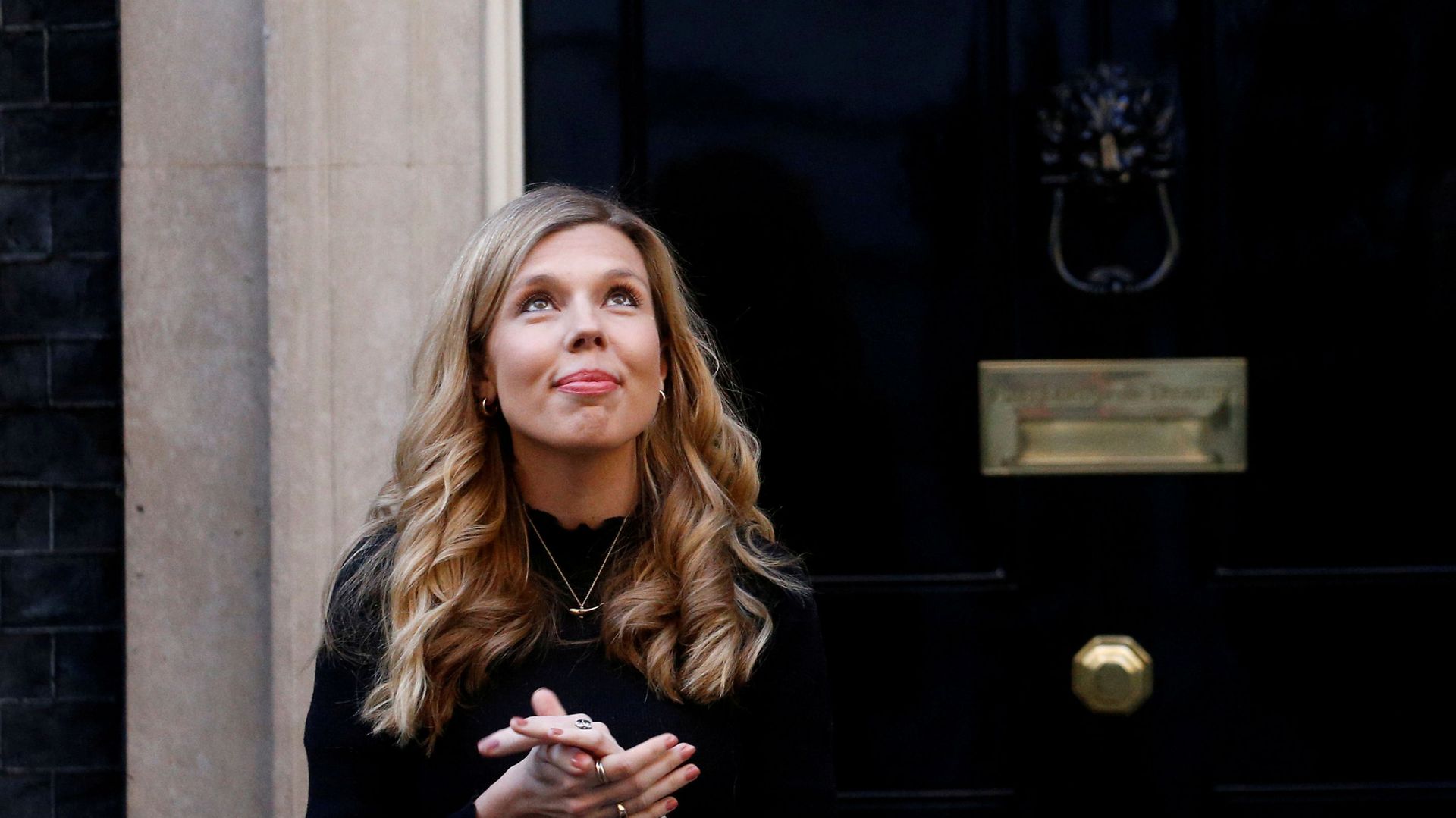 FILE PHOTO: Britain's Prime Minister Boris Johnson partner Carrie Symonds reacts outside 10 Downing Street during the Clap for our Carers campaign in support of the NHS, following the outbreak of the coronavirus disease (COVID-19), London, Britain, May 14, 2020. FILE PHOTO: Britain's Prime Minister Boris Johnson partner Carrie Symonds reacts outside 10 Downing Street during the Clap for our Carers campaign in support of the NHS, following the outbreak of the coronavirus disease (COVID-19), London, Britain, May 14, 2020. - Sputnik International, 1920, 21.02.2021