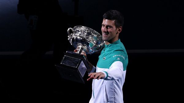 Australian Open - Men's Singles Final - Melbourne Park, Melbourne, Australia, February 21, 2021 Serbia's Novak Djokovic celebrates with the trophy after winning his final match against Russia's Daniil Medvedev Australian Open - Men's Singles Final - Melbourne Park, Melbourne, Australia, February 21, 2021 Serbia's Novak Djokovic celebrates with the trophy after winning his final match against Russia's Daniil Medvedev - Sputnik International