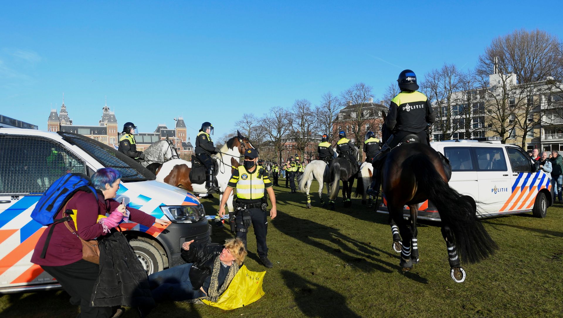 A woman lies on the ground after getting run down by a police officer on a horse, as people protest against the coronavirus disease (COVID-19) restrictions in Amsterdam, Netherlands, February 21, 2021. A woman lies on the ground after getting run down by a police officer on a horse, as people protest against the coronavirus disease (COVID-19) restrictions in Amsterdam, Netherlands, February 21, 2021. - Sputnik International, 1920, 21.02.2021