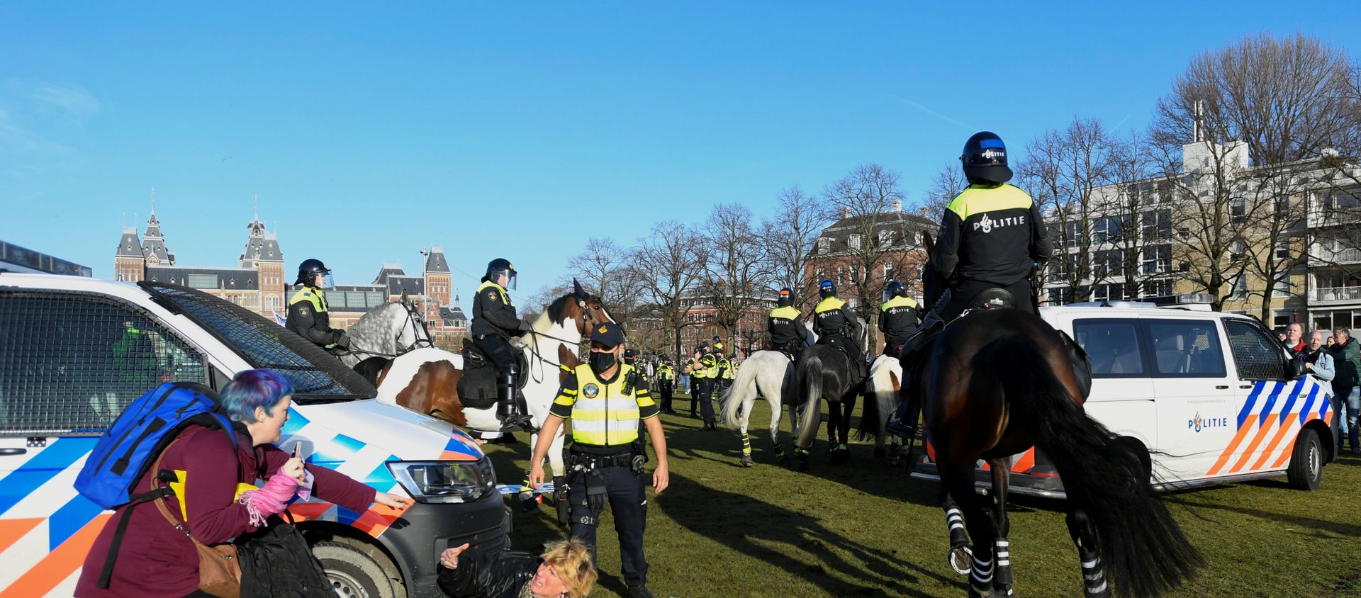 A woman lies on the ground after getting run down by a police officer on a horse, as people protest against the coronavirus disease (COVID-19) restrictions in Amsterdam, Netherlands, February 21, 2021. A woman lies on the ground after getting run down by a police officer on a horse, as people protest against the coronavirus disease (COVID-19) restrictions in Amsterdam, Netherlands, February 21, 2021. - Sputnik International, 1920, 21.02.2021