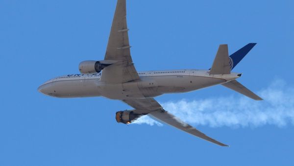 United Airlines flight UA328, carrying 231 passengers and 10 crew on board, returns to Denver International Airport with its starboard engine on fire after it called a Mayday alert, over Denver, Colorado, U.S. February 20, 2021.  - Sputnik International