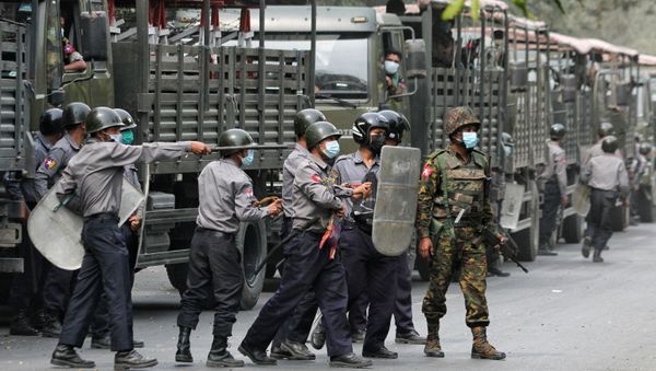 Police and soldiers are seen during a protests against the military coup, in Mandalay, Myanmar, February 20, 2021 - Sputnik International