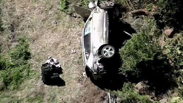 The vehicle of golfer Tiger Woods, who was rushed to hospital after suffering multiple injuries, lies on its side after being involved in a single-vehicle accident in Los Angeles, California, U.S. in a still image from video taken February 23, 2021 - Sputnik International
