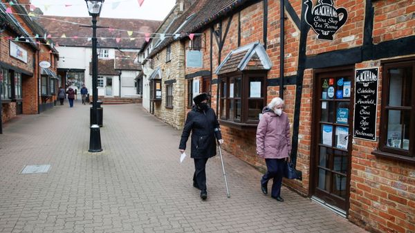 Two women walk past a closed tea room, amid the outbreak of the coronavirus disease (COVID-19), in Buckingham, Britain, February 23, 2021 - Sputnik International