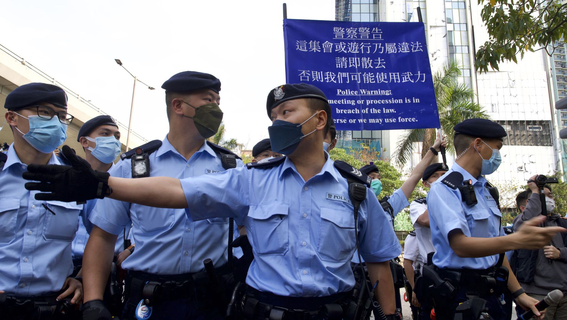 Police officers raise a warning flag against supporters gathered outside a court in Hong Kong Monday, March 1, 2021. Hong Kong police on Monday brought 47 pro-democracy activists to court on charges of conspiracy to commit subversion under the national security law imposed on the city by Beijing last year. Police officers raise a warning flag against supporters gathered outside a court in Hong Kong Monday, March 1, 2021. Hong Kong police on Monday brought 47 pro-democracy activists to court on charges of conspiracy to commit subversion under the national security law imposed on the city by Beijing last year. - Sputnik International, 1920, 01.03.2021