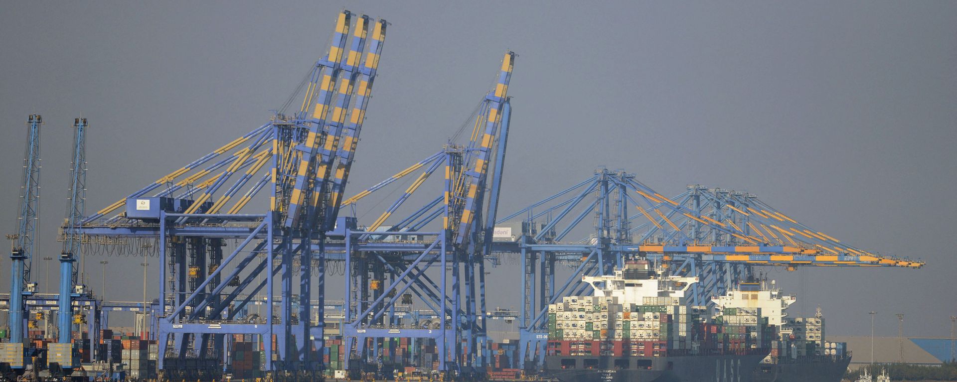 This photo taken on December 21, 2016 shows a container ship (R) docked at India's Adani Port Special Economic Zone (APSEZ) in Mundra This photo taken on December 21, 2016 shows a container ship (R) docked at India's Adani Port Special Economic Zone (APSEZ) in Mundra - Sputnik International, 1920, 14.10.2021