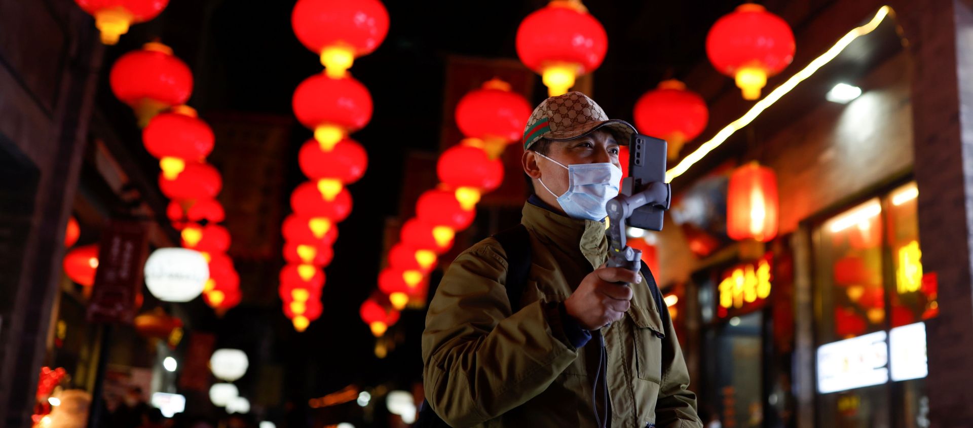 A man wearing a face mask following an outbreak of the coronavirus disease (COVID-19) uses his phone while walking near the Qianmen street ahead of Lunar New Year celebrations, in Beijing, China February 10, 2021 A man wearing a face mask following an outbreak of the coronavirus disease (COVID-19) uses his phone while walking near the Qianmen street ahead of Lunar New Year celebrations, in Beijing, China February 10, 2021 - Sputnik International, 1920, 02.03.2021
