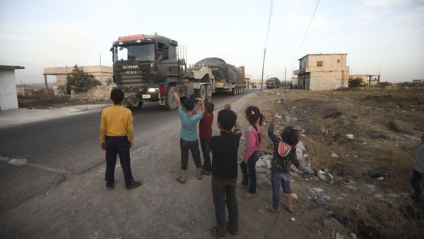 Turkish military convoy drives through the village of Urum al-Jawz, in Idlib province, Syria, Tuesday, Oct. 20, 2020.  - Sputnik International