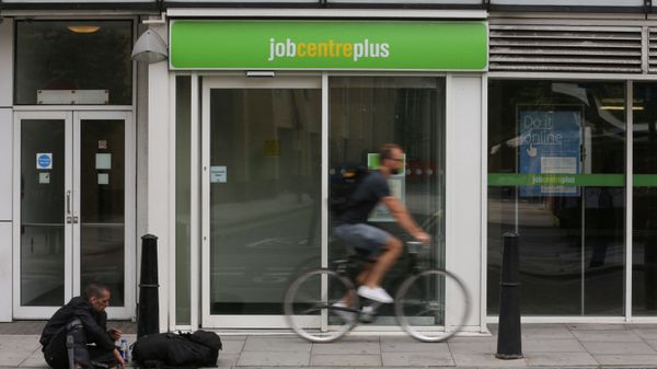 A cyclist passes the entrance to a job centre in east London on 20 July 2016 - Sputnik International