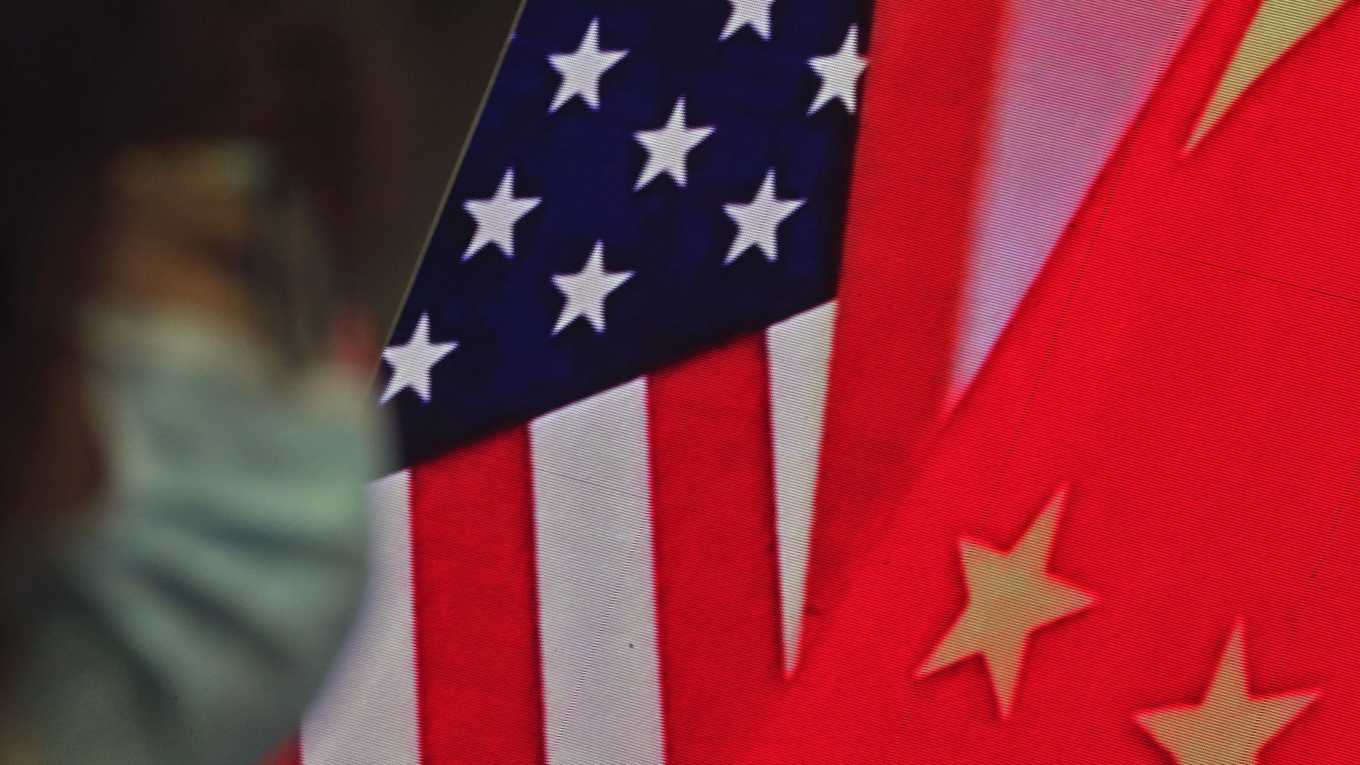 A woman wearing a face mask to help curb the spread of the coronavirus sits near a screen showing China and U.S. flags as she listens to a speech by Chinese Foreign Minister Wang Yi at the Lanting Forum on bringing China-U.S. relations back to the right track, at the Ministry of Foreign Affairs office in Beijing on Monday, Feb. 22, 2021 - Sputnik International, 1920, 13.12.2021