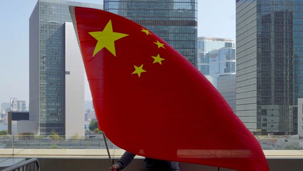 A pro-China supporter holds a Chinese national flags outside High Court in Hong Kong Thursday, Feb. 18, 2021.  - Sputnik International