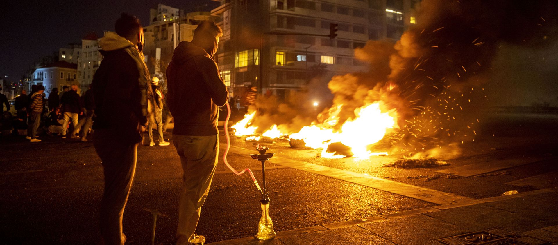 Protesters smoke water pipes in front burning tires that were set on fire to block a road, at Martyrs Square, in downtown Beirut, Lebanon, Saturday, March 6, 2021. Protesters smoke water pipes in front burning tires that were set on fire to block a road, at Martyrs Square, in downtown Beirut, Lebanon, Saturday, March 6, 2021. - Sputnik International, 1920, 07.03.2021
