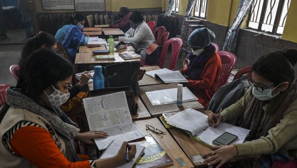 Teachers attend online classes with their mobile phones as sanitization work is in progress  prior to its reopening for higher classes after the spread of the Covid-19 coronavirus, at a private school in Kolkata on February 3, 2021. - Sputnik International