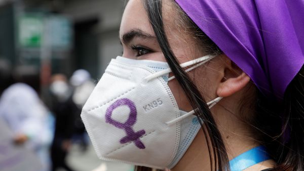 A woman wearing a face mask takes part in a protest to mark International Women's Day in La Paz, Bolivia - Sputnik International