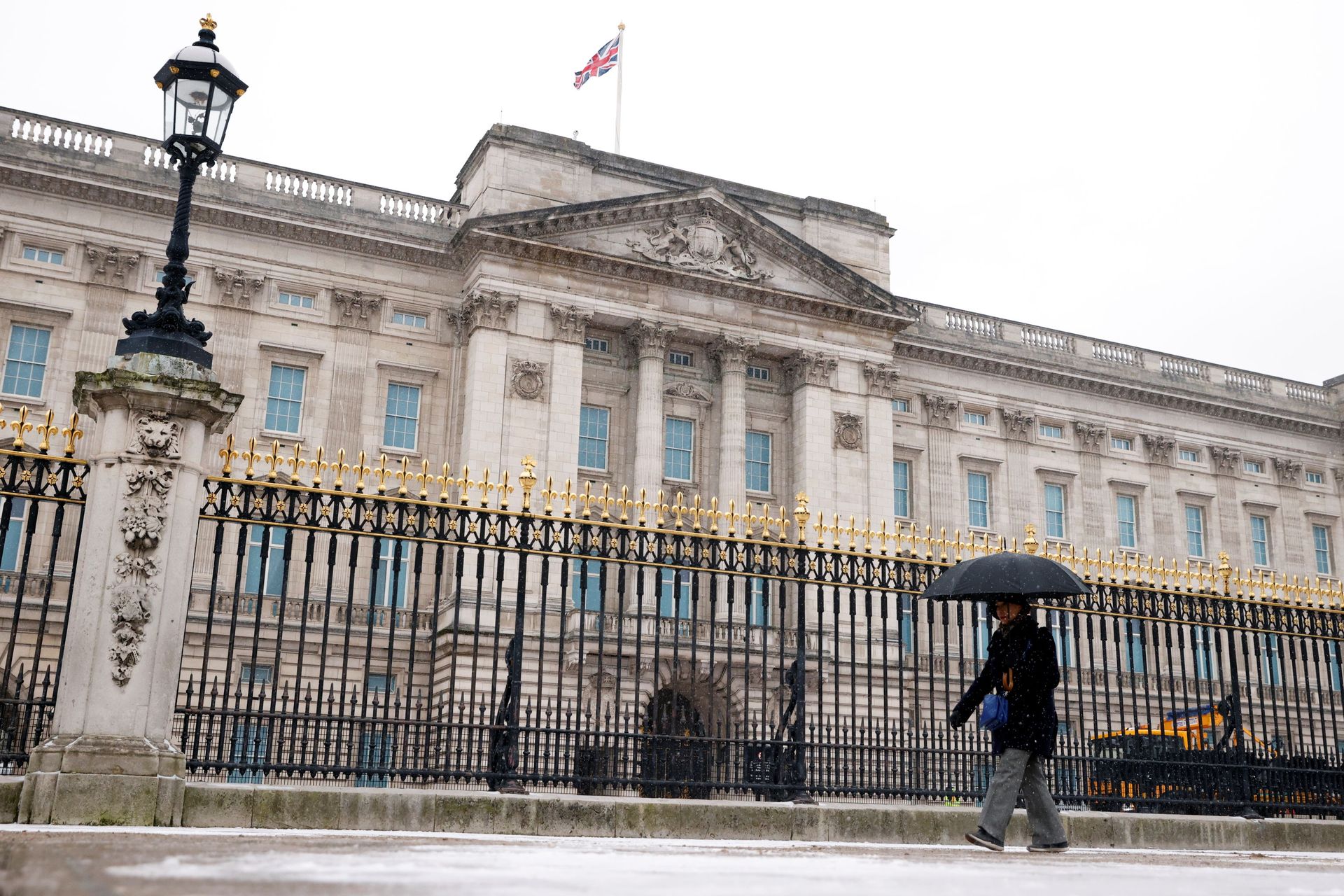 A woman holding an umbrella walks past Buckingham Palace during a snowfall, - Sputnik International, 1920, 05.10.2021