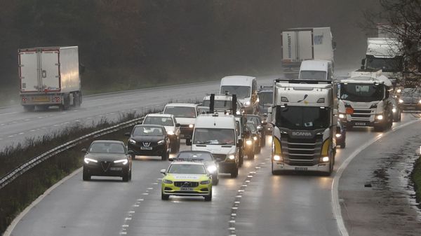 Traffic including freight lorries drive under police escort to manage the traffic on the M20 motorway which leads to the Port of Dover at Mersham in Kent, south east England on December 21, 2020, as a string of countries banned travel including accompanied freight arriving from the UK, due to the rapid spread of a more-infectious new coronavirus strain. - Britain's critical south coast port at Dover said on Sunday it was closing to all accompanied freight and passengers due to the French border restrictions until further notice.  - Sputnik International