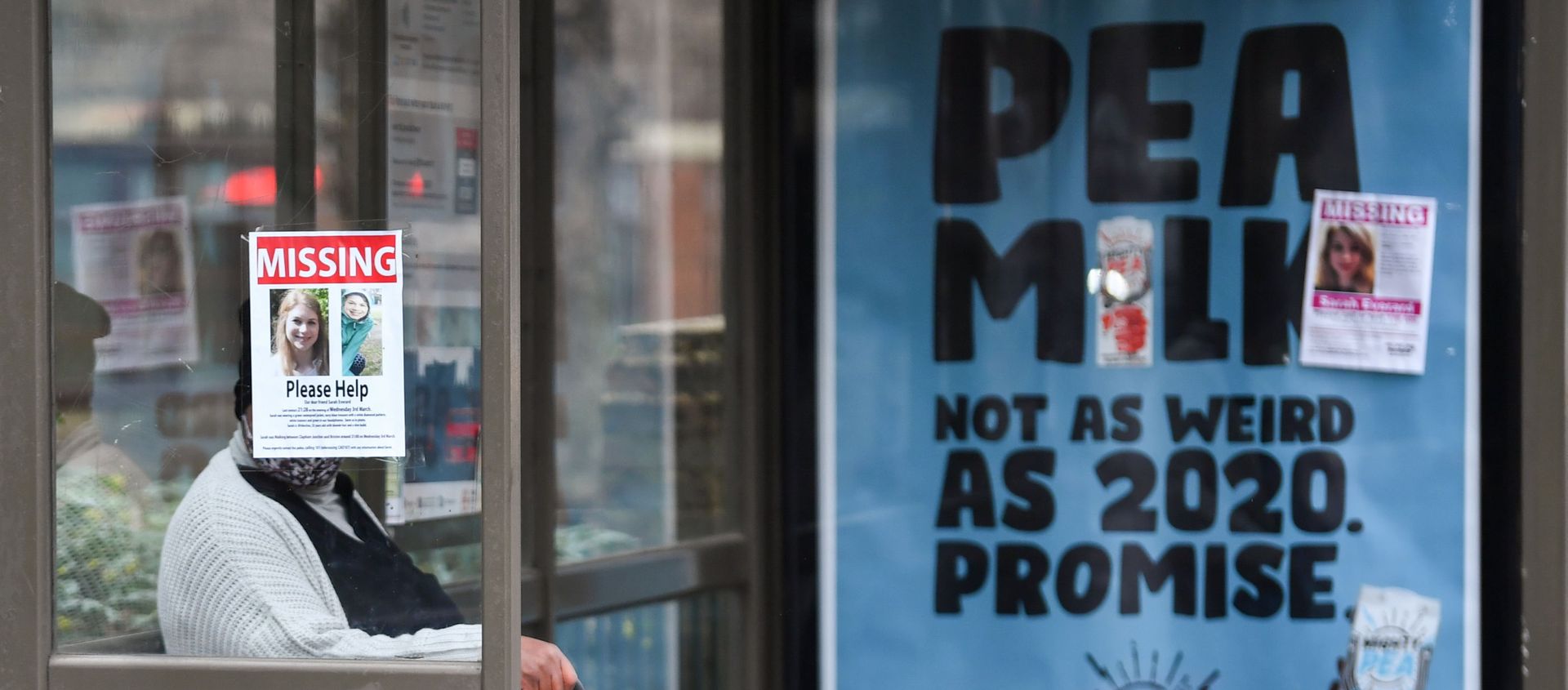 A person sits at a bus stop next to signs that show pictures of Sarah Everard, who disappeared last week, as police continue to search parts of Clapham, in London, Britain, March 10, 2021 - Sputnik International, 1920, 16.03.2021