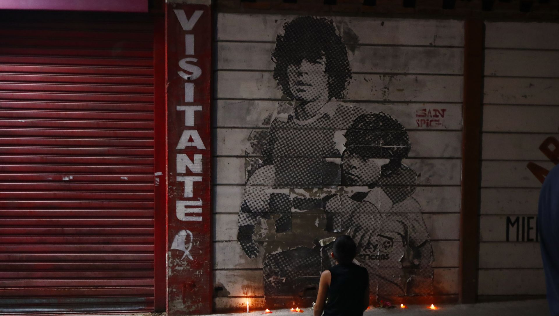 A boy kneels in front of a mural of Diego Maradona decorated with canddles outside the stadium of Argentinos Juniors soccer club, where he started as a professional footballer, in Buenos Aires, Argentina, Wednesday, Nov. 25, 2020. The Argentine soccer great who was among the best players ever and who led his country to the 1986 World Cup title died from a heart attack on Wednesday at his home in Buenos Aires. He was 60. A boy kneels in front of a mural of Diego Maradona decorated with canddles outside the stadium of Argentinos Juniors soccer club, where he started as a professional footballer, in Buenos Aires, Argentina, Wednesday, Nov. 25, 2020. The Argentine soccer great who was among the best players ever and who led his country to the 1986 World Cup title died from a heart attack on Wednesday at his home in Buenos Aires. He was 60. - Sputnik International, 1920, 10.03.2021