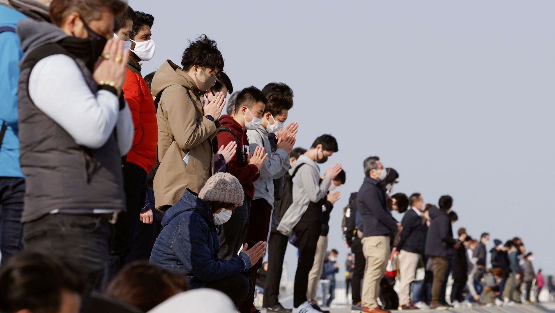 Participants pray and observe a moment of silence towards the sea at 2:46 p.m. (05:46 GMT), the time when the 9.0-magnitude earthquake struck off Japan's coast in 2011, at Arahama district in Sendai, northeastern Japan, March 11, 2021, to mark the 10-year anniversary of the 2011 earthquake and tsunami that killed thousands and set off a nuclear crisis Participants pray and observe a moment of silence towards the sea at 2:46 p.m. (05:46 GMT), the time when the 9.0-magnitude earthquake struck off Japan's coast in 2011, at Arahama district in Sendai, northeastern Japan, March 11, 2021, to mark the 10-year anniversary of the 2011 earthquake and tsunami that killed thousands and set off a nuclear crisis - Sputnik International, 1920, 11.03.2021