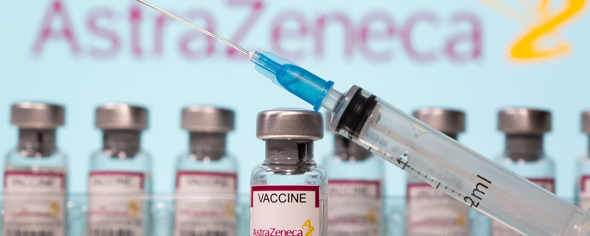 Vials labelled AstraZeneca COVID-19 Coronavirus Vaccine and a syringe are seen in front of a displayed AstraZeneca logo in this illustration taken March 10, 2021. REUTERS/Dado Ruvic/Illustration Vials labelled AstraZeneca COVID-19 Coronavirus Vaccine and a syringe are seen in front of a displayed AstraZeneca logo in this illustration taken March 10, 2021. REUTERS/Dado Ruvic/Illustration - Sputnik International, 1920, 12.05.2021
