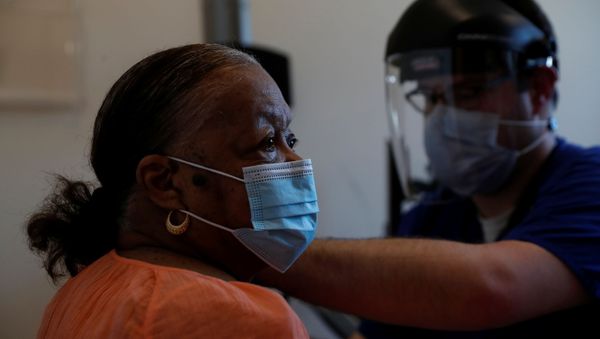 Lucy Johnson, 79, receives the second dose of the Moderna coronavirus disease (COVID-19) vaccination shot at the SMH Internal Medicine Practice administered by the Sarasota Memorial Health Care System partnered with Newtown community and church leaders in Sarasota, Florida, February 10, 2021 - Sputnik International
