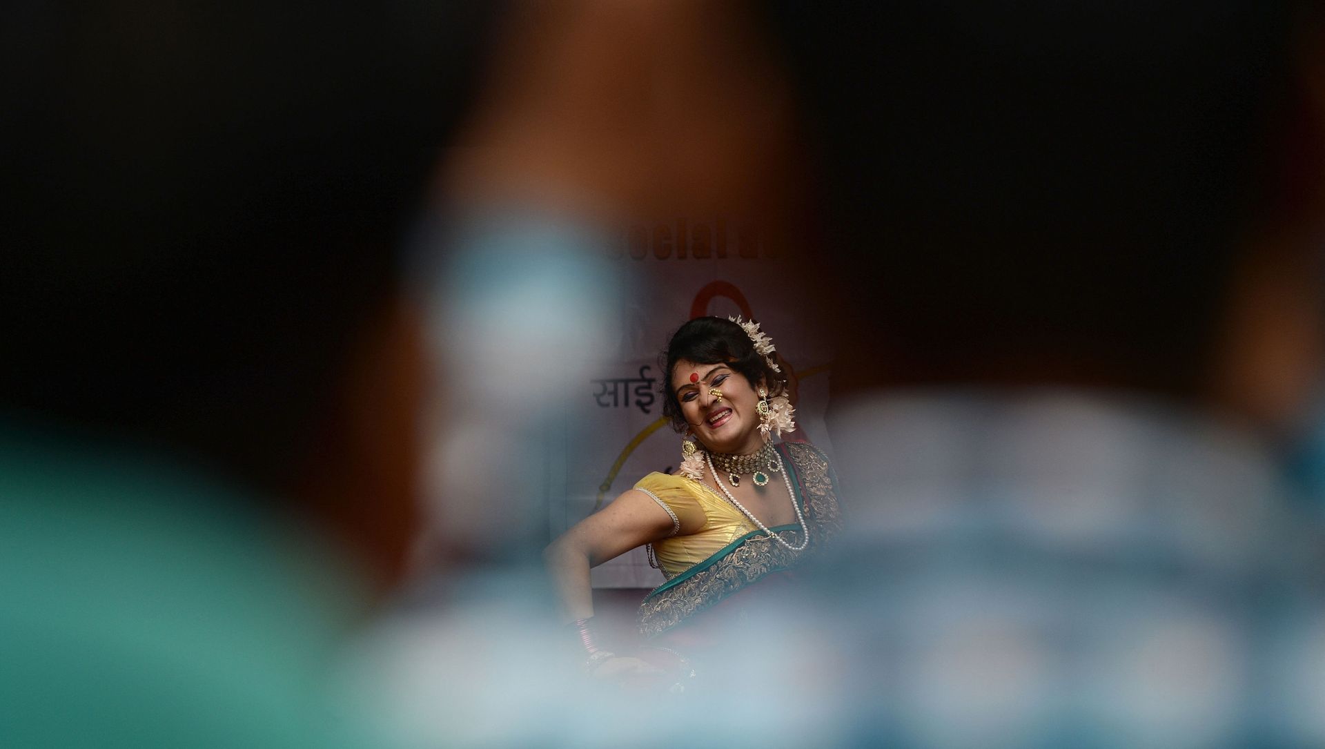 A traditional Lavani folk dancer is seen through a gap among the audience during a performance for sex workers in the red light district of Kamathipura in Mumbai on 28 August 2015, ahead of the Hindu festival 'Raksha Bandhan' A traditional Lavani folk dancer is seen through a gap among the audience during a performance for sex workers in the red light district of Kamathipura in Mumbai on 28 August 2015, ahead of the Hindu festival 'Raksha Bandhan' - Sputnik International, 1920, 15.03.2021