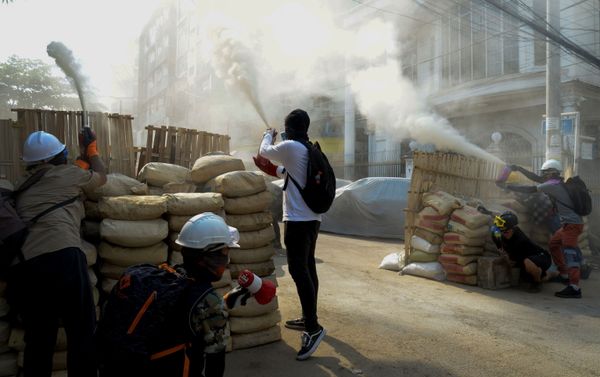 Anti-coup demonstrators sprays fire extinguishers over a barricade during a protests in Yangon, Myanmar - Sputnik International