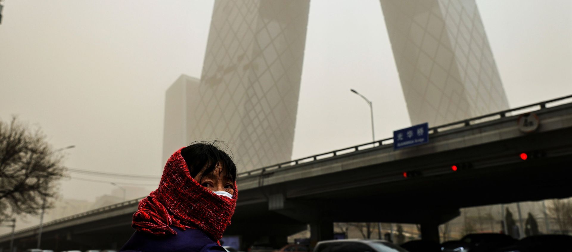 A woman wearing a head covering is seen in front of the headquarters of China's state media broadcaster CCTV that is shrouded in a haze after a sandstorm in the Central Business District of Beijing, China. A woman wearing a head covering is seen in front of the headquarters of China's state media broadcaster CCTV that is shrouded in a haze after a sandstorm in the Central Business District of Beijing, China. - Sputnik International, 1920, 15.03.2021