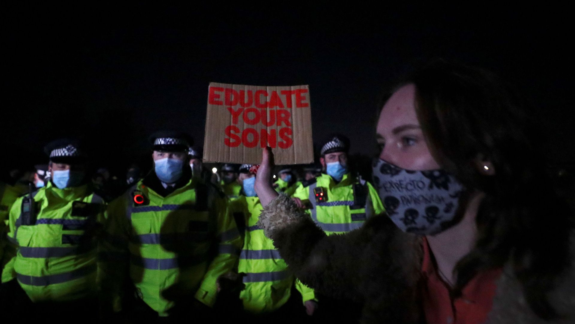 A woman hold a sign in front of police as people gather at a memorial site in Clapham Common Bandstand, following the kidnap and murder of Sarah Everard, in London, Britain March 13, 2021. REUTERS/Hannah McKay A woman hold a sign in front of police as people gather at a memorial site in Clapham Common Bandstand, following the kidnap and murder of Sarah Everard, in London, Britain March 13, 2021. REUTERS/Hannah McKay - Sputnik International, 1920, 31.03.2021