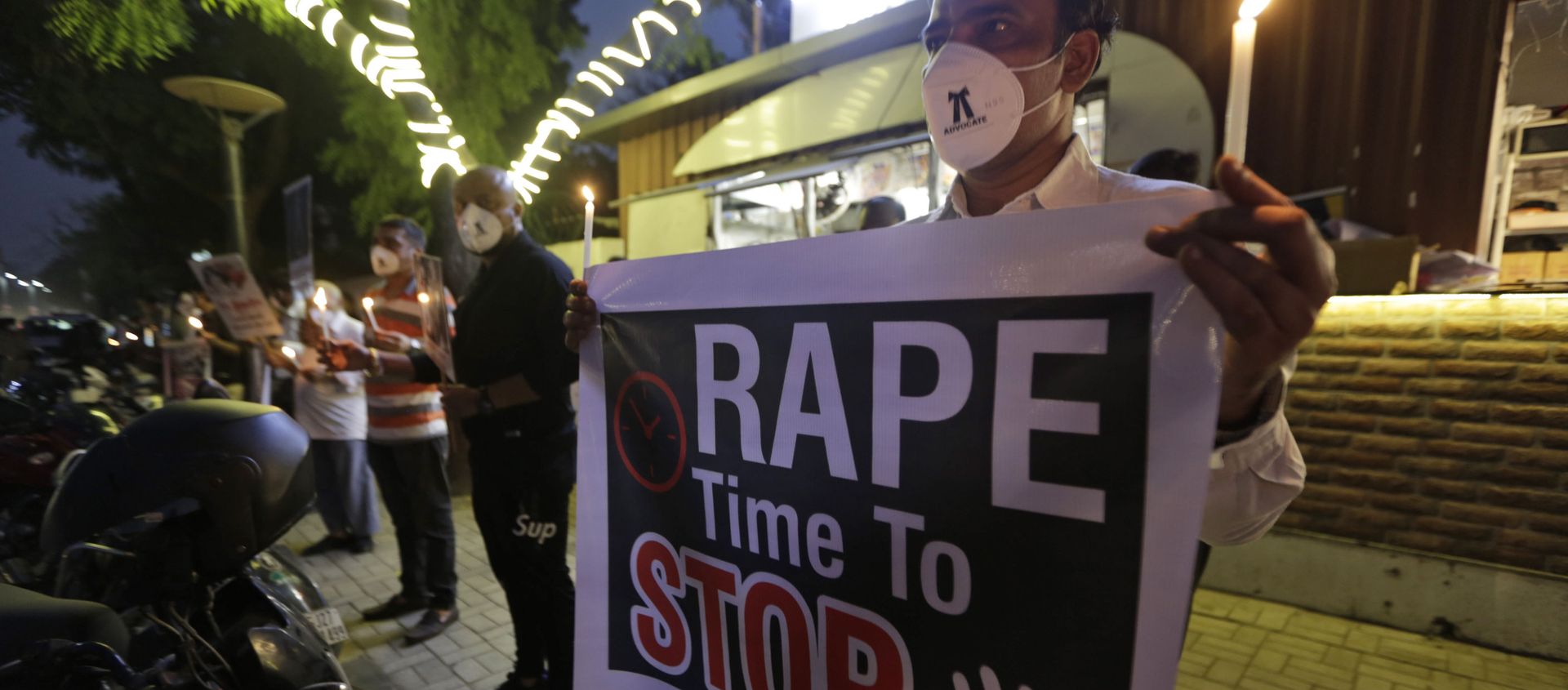 A man holds a poster and candle during a protest against the alleged gang rape and killing of a Dalit woman, in Ahmedabad, India, Tuesday, Oct. 6, 2020 A man holds a poster and candle during a protest against the alleged gang rape and killing of a Dalit woman, in Ahmedabad, India, Tuesday, Oct. 6, 2020 - Sputnik International, 1920, 27.08.2021