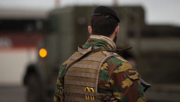 A Belgian solider patrols in a temporary military zone as vehicles arrive from a British naval vessel, taking part in U.S.-led war games, as they are unloaded at the Port of Antwerp in Antwerp, Belgium, Monday Feb. 3, 2020.  - Sputnik International