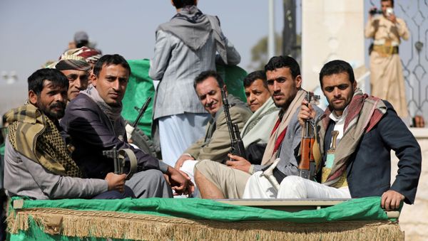 Armed Houthi followers ride on the back of a truck after participating in a funeral of Houthi fighters killed in recent fighting against government forces in Yemen's oil-rich province of Marib, in Sanaa, Yemen February 20, 2021.  - Sputnik International