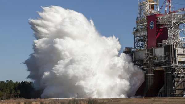 The core stage for the first flight of NASA’s Space Launch System rocket is seen in the B-2 Test Stand during a second hot fire test, Thursday, March 18, 2021, at NASA’s Stennis Space Center near Bay St. Louis, Mississippi. - Sputnik International