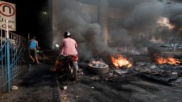 Smoke billows from burning tyres set alight to create smoke cover during a crackdown at Bayint Naung Junction in Yangon, Myanmar March 16, 2021, in this photograph obtained by Reuters. - Sputnik International