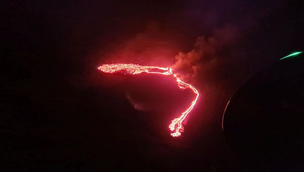 Lava streams are seen during a volcanic eruption in Fagradalsfjall, Reykjanes, Iceland, March 19, 2021 in this still image taken from social media. - Sputnik International