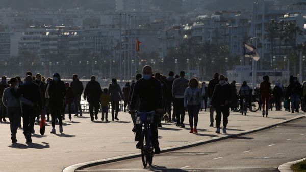People walk and cycle on the Promenade des Anglais in Nice, as France's 16 hardest-hit departments go into a new month-long lockdown imposed to slow the rate of the coronavirus disease (COVID-19) contagion, France March 20, 2021. - Sputnik International