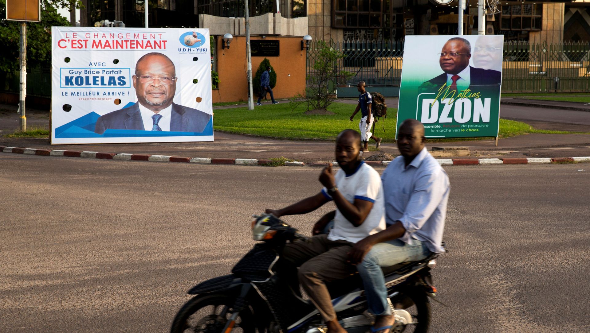 Men on a motorbike ride past billboards of presidential candidates and leading opposition leaders Guy Brice Parfait Kolelas and Mathias Dzon, in Brazzaville, Republic of Congo, 17 March 2021 Men on a motorbike ride past billboards of presidential candidates and leading opposition leaders Guy Brice Parfait Kolelas and Mathias Dzon, in Brazzaville, Republic of Congo, 17 March 2021 - Sputnik International, 1920, 22.03.2021