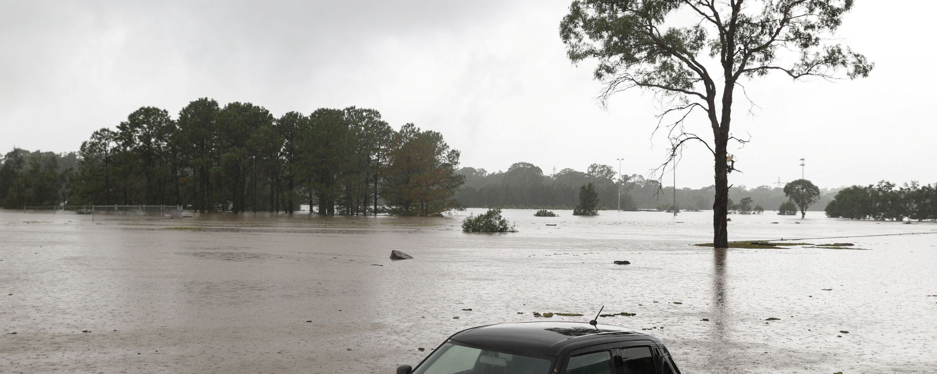 A partially submerged car is seen abandoned in floodwaters in the suburb of Windsor as the state of New South Wales experiences widespread flooding and severe weather, in Sydney, Australia, March 22, 2021 - Sputnik International, 1920, 22.03.2021