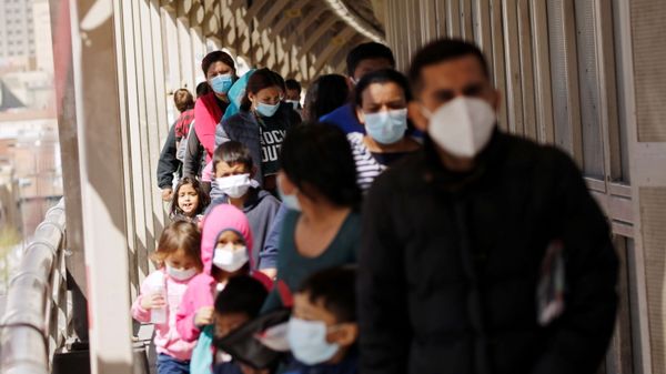 Asylum-seeking migrants from Central America, who were airlifted from Brownsville to El Paso, Texas, and deported from the U.S., walk towards Mexico at the Paso del Norte International border bridge, in this picture taken from Ciudad Juarez, Mexico March 19, 2021.  - Sputnik International