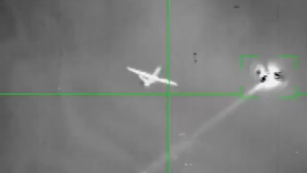 A UAV purported to be a US MQ-9 Reaper fires a projectile before being hit by a Houthi anti-air missile. It's unclear whether the drone fired its own weapon or a defensive flare. - Sputnik International