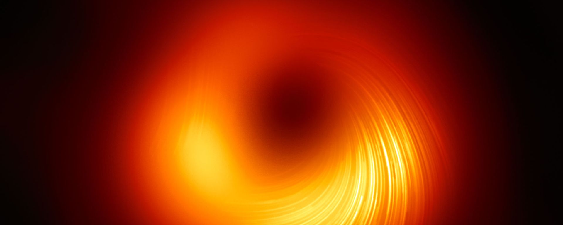 Polarised view of the black hole in M87. The lines mark the orientation of polarisation, which is related to the magnetic field around the shadow of the black hole. - Sputnik International, 1920, 18.10.2022