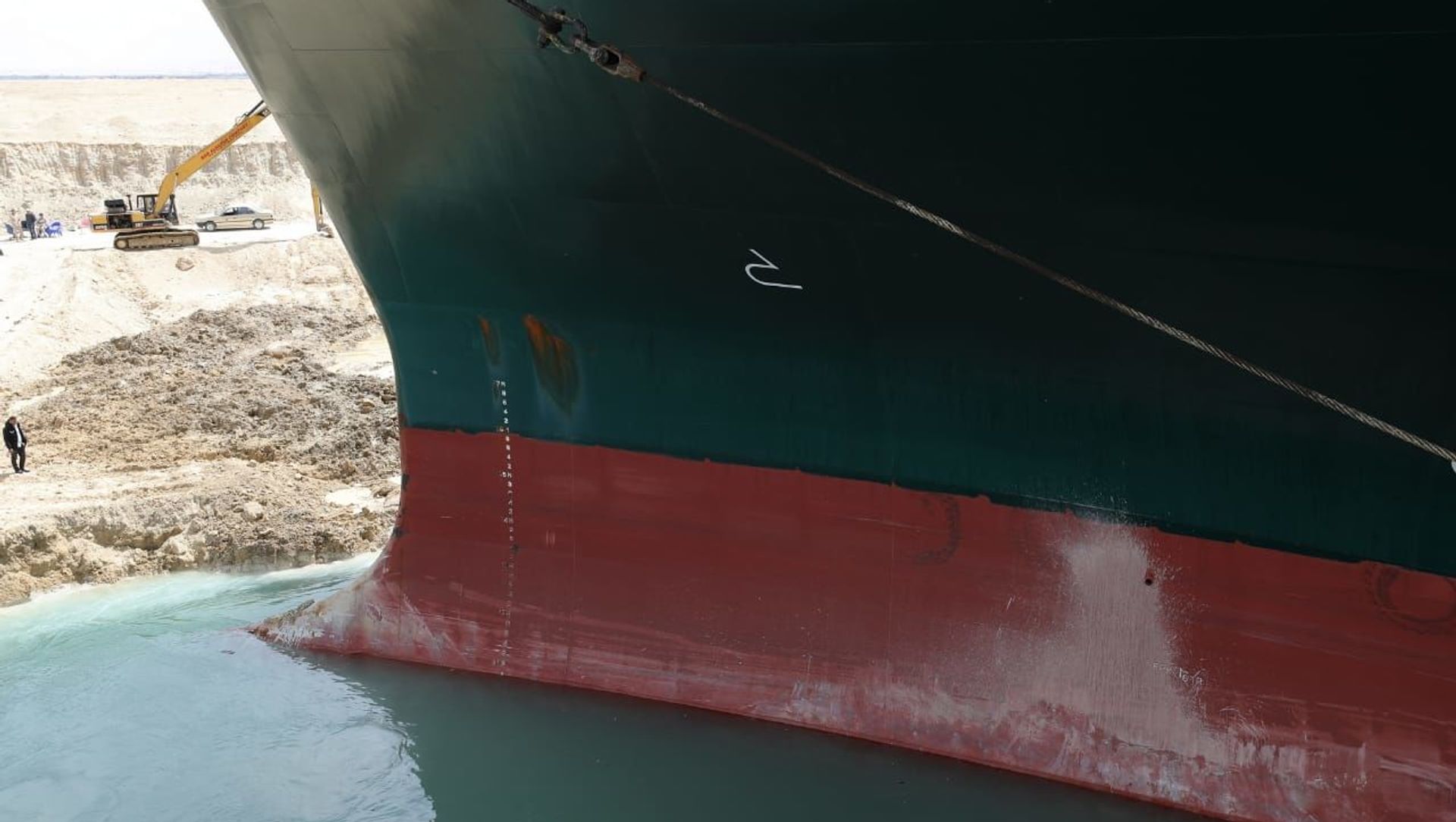 An excavator attempts to free stranded container ship Ever Given, one of the world's largest container ships, after it ran aground, in Suez Canal, Egypt March 25, 2021 An excavator attempts to free stranded container ship Ever Given, one of the world's largest container ships, after it ran aground, in Suez Canal, Egypt March 25, 2021 - Sputnik International, 1920, 28.03.2021