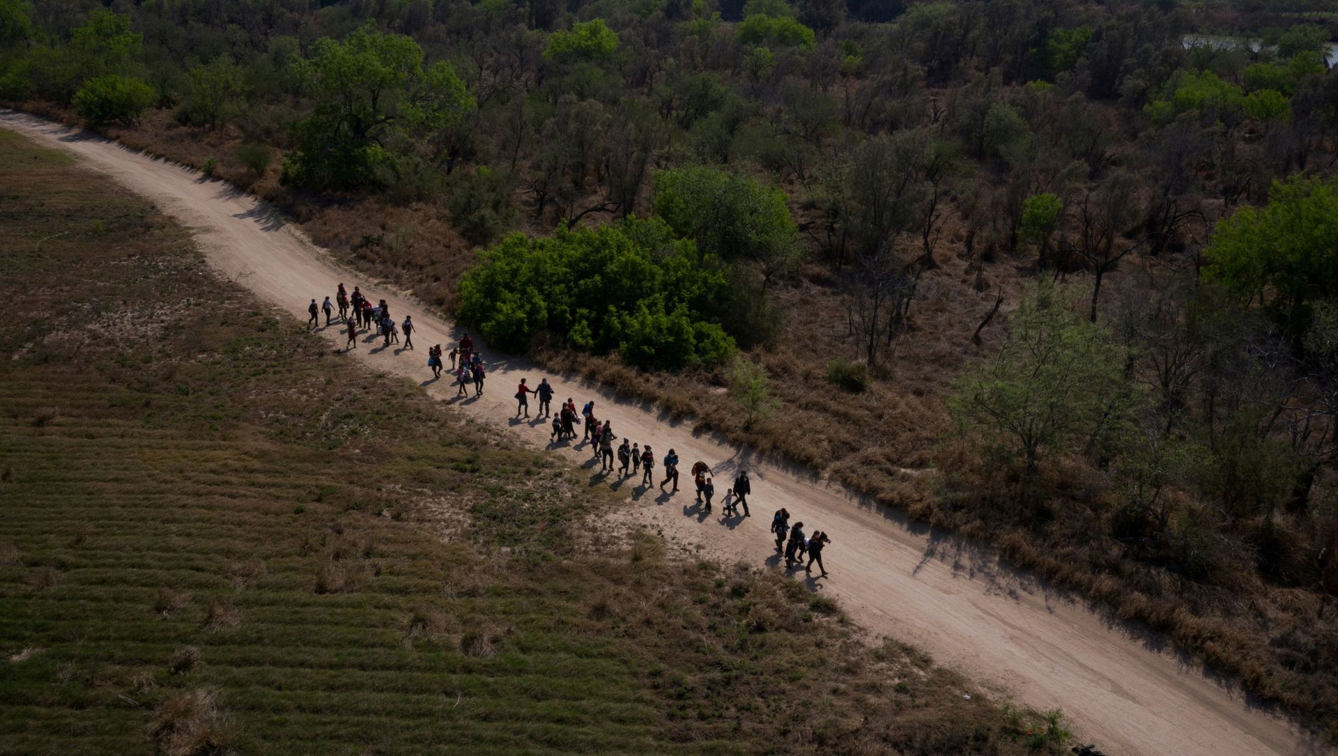 Asylum seeking migrant families from Central America walk towards the border wall after crossing the Rio Grande river into the United States from Mexico on rafts in Penitas, Texas, U.S., March 26, 2021 Asylum seeking migrant families from Central America walk towards the border wall after crossing the Rio Grande river into the United States from Mexico on rafts in Penitas, Texas, U.S., March 26, 2021 - Sputnik International, 1920, 28.03.2021
