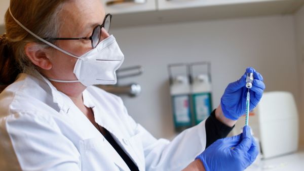 Family doctor Elke Happich prepares a syringe containing a dose of the Pfizer-BioNTech coronavirus disease (COVID-19) vaccine to vaccinate patients at their homes in Cologne, Germany - Sputnik International