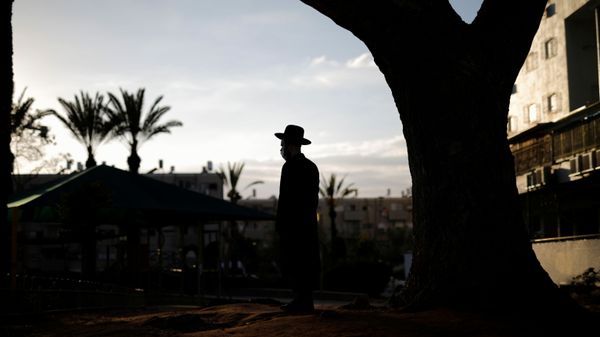 An ultra-Orthodox Jewish man looks on as others dip cooking utensils in boiling water to remove remains of leaven in preparation for the upcoming Jewish holiday of Passover as the country begins to emerge from coronavirus disease (COVID-19) pandemic closures due to it's rapid vaccine roll-out, in Ashdod, Israel March 25, 2021.  - Sputnik International