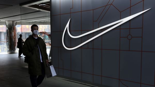 A man walks past a store of the sporting goods retailer Nike Inc at a shopping complex in Beijing, China March 25, 2021 - Sputnik International