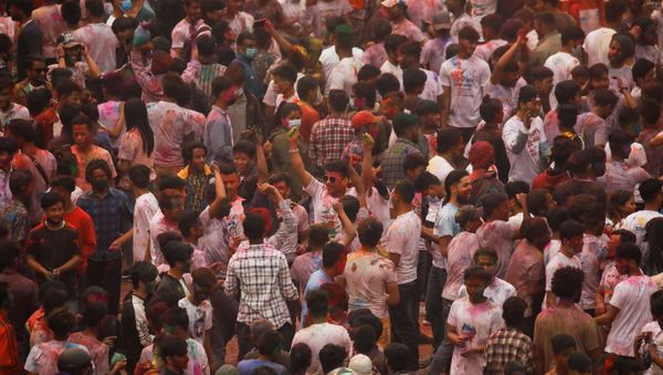 People are smeared with coloured powder as they celebrate Holi, the festival of colours, amidst the spread of the coronavirus disease (COVID-19), in Kathmandu, Nepal March 28, 2021.  - Sputnik International