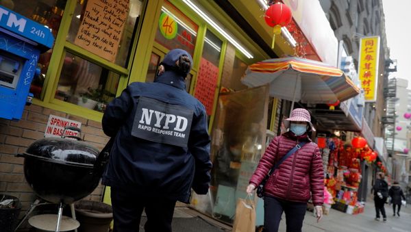 Detective Suk Too, of the New York Police Department (NYPD) Community Affairs Rapid Response Team, checks on businesses in the Chinatown section of Manhattan following the deadly shootings at three spas in Georgia, in New York City, New York, U.S., March 17, 2021 - Sputnik International
