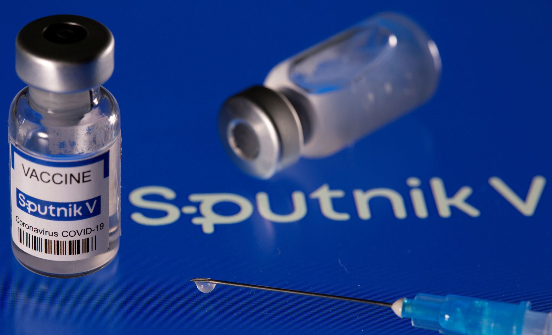Vial labelled Sputnik V coronavirus disease (COVID-19) vaccine placed on displayed Sputnik V logo is seen in this illustration picture taken March 24, 2021. - Sputnik International, 1920, 12.10.2021