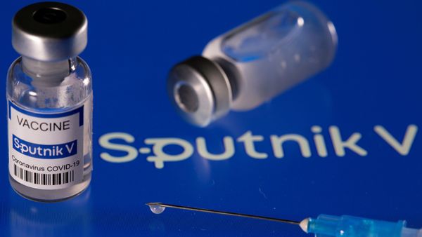 Vial labelled Sputnik V coronavirus disease (COVID-19) vaccine placed on displayed Sputnik V logo is seen in this illustration picture taken March 24, 2021. - Sputnik International